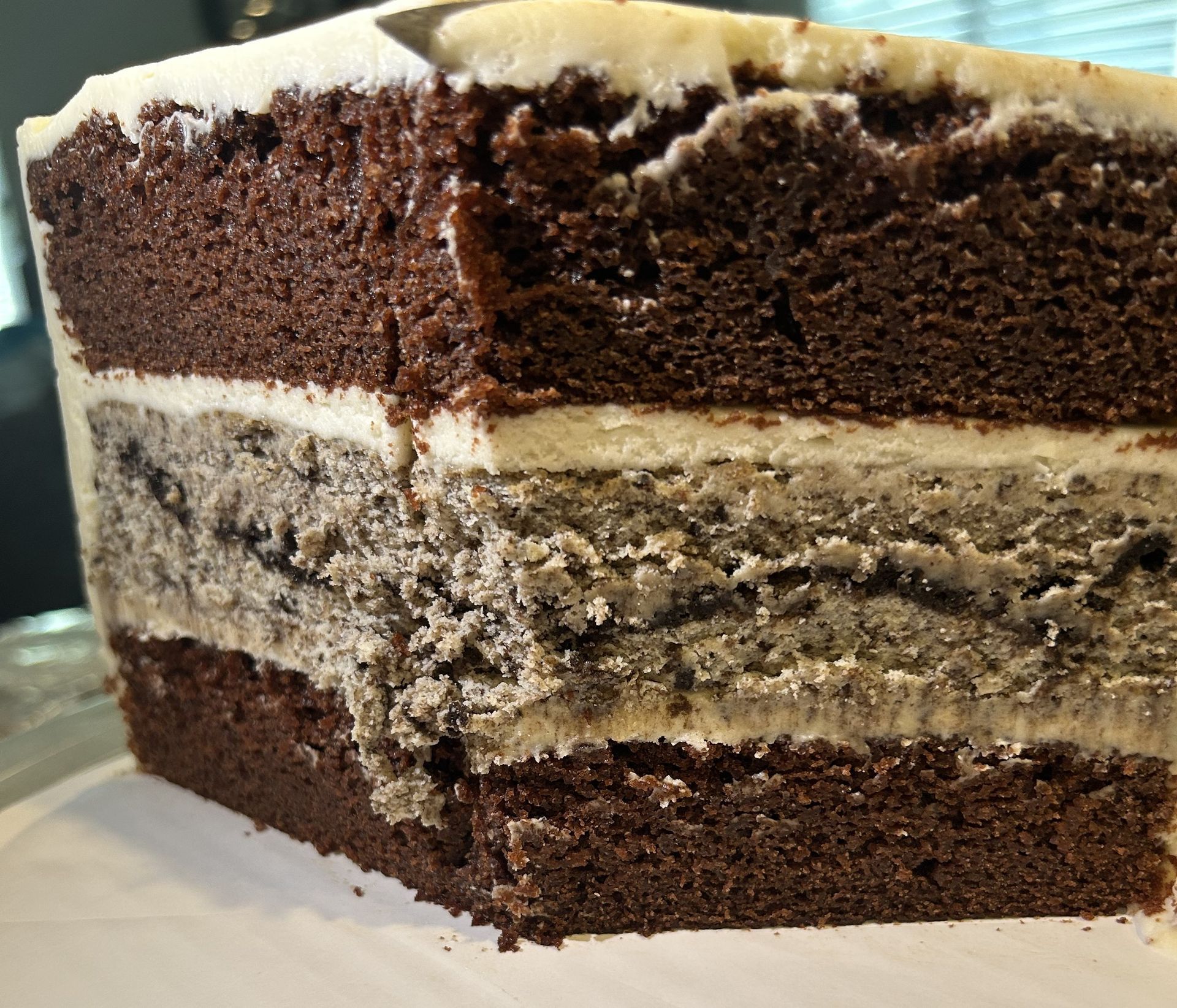 Chocolate cake with visible layers, including a cookies and cream filling, close-up shot.