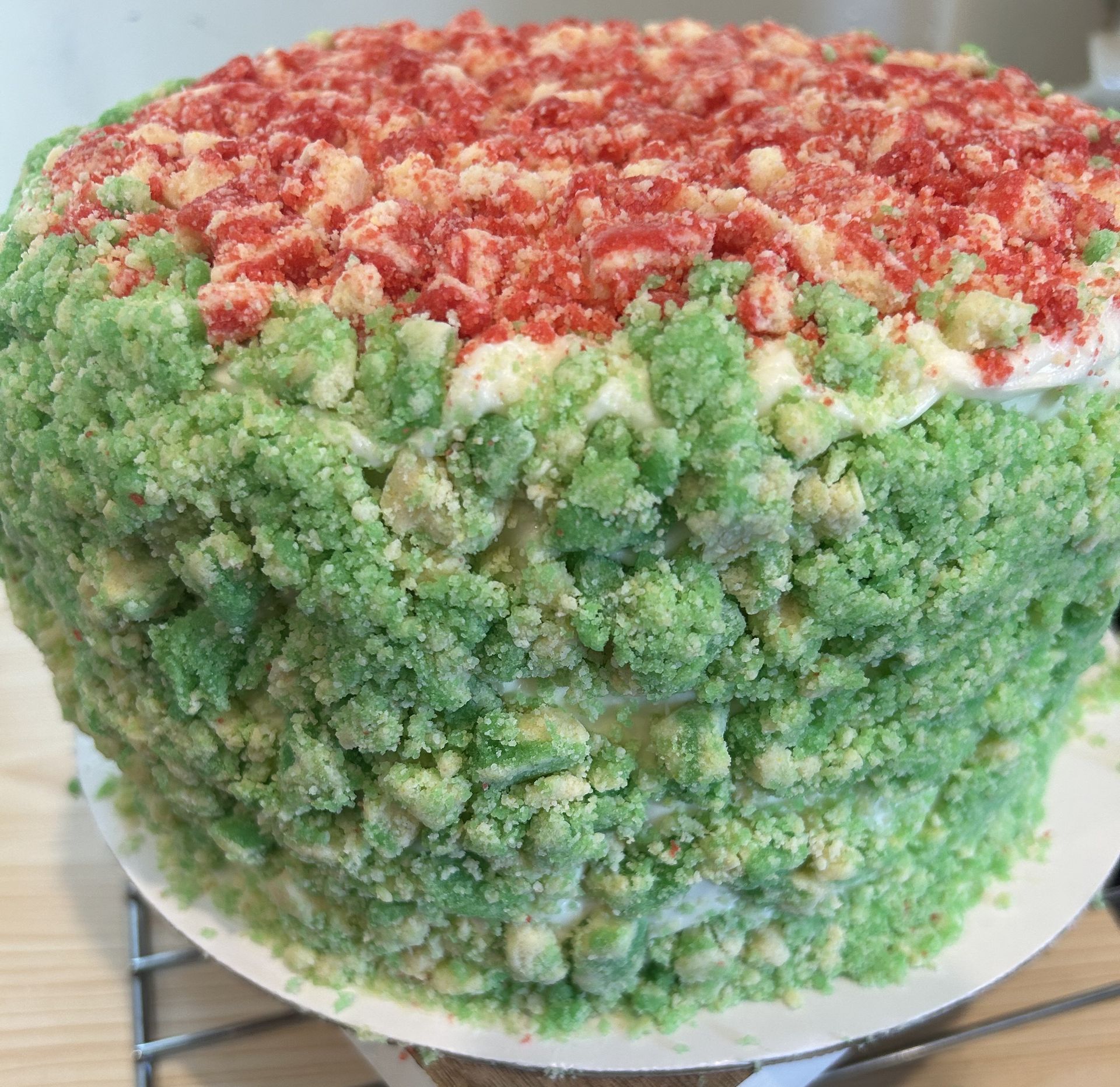 Watermelon-themed cake with green, crumbly outer layer and red crumb top.