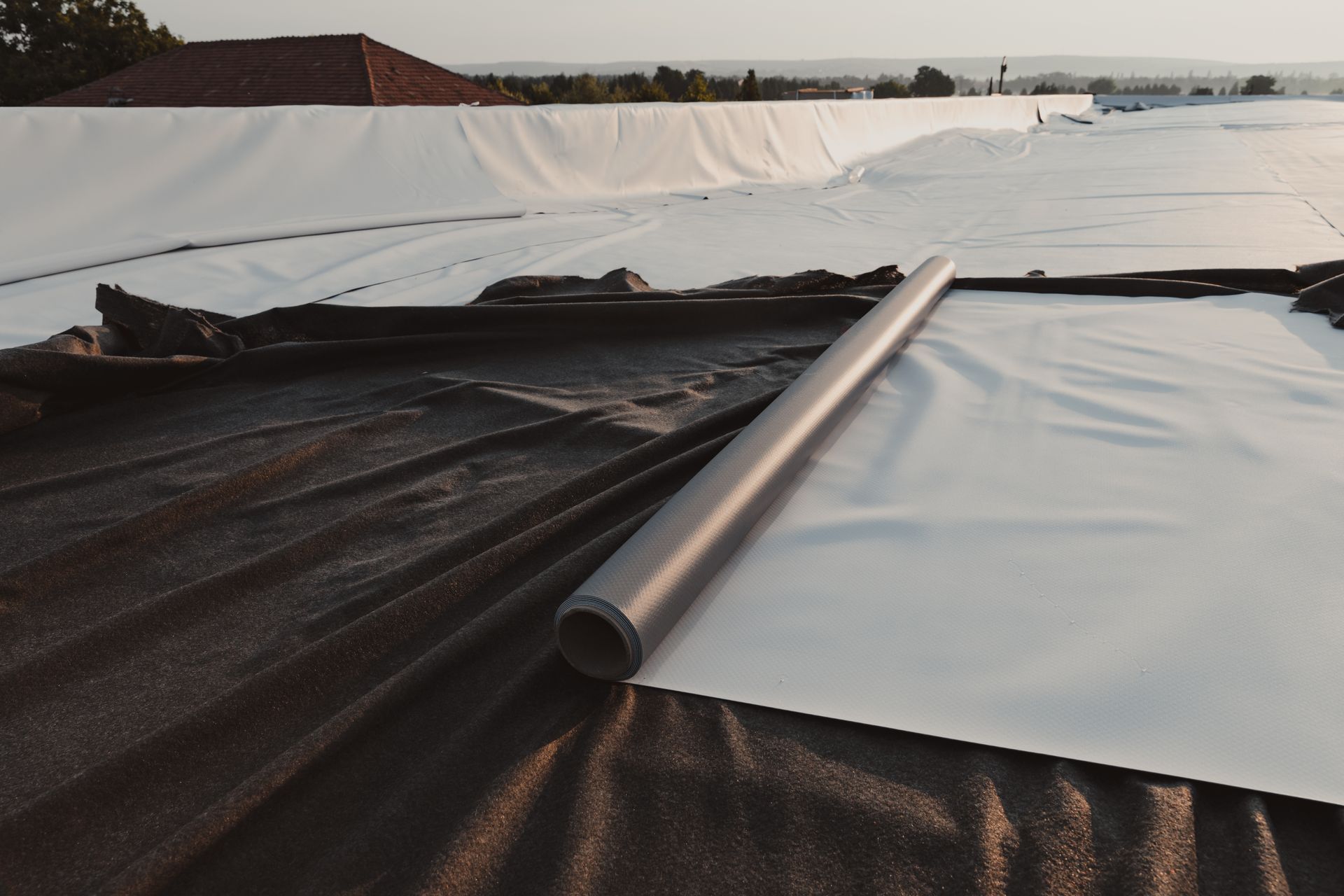 Rolls of roofing PVC membrane and geotextile, essential for durable and weather-resistant construction.