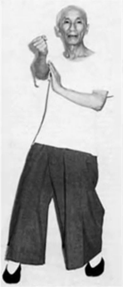 A black and white photo of a man in a white shirt and black pants