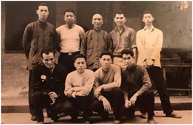 A black and white photo of a group of men posing for a picture