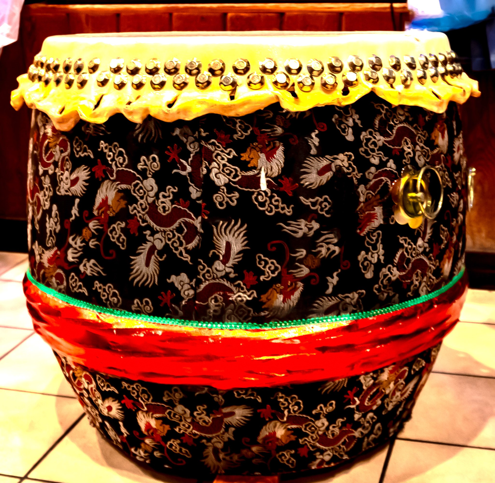 A large drum with a dragon pattern on it