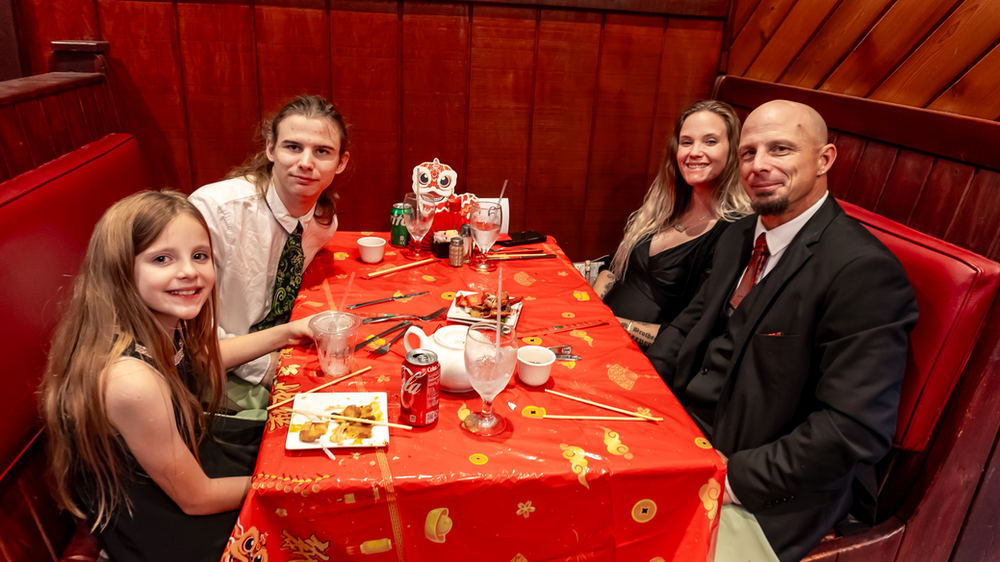 A family is sitting at a table in a restaurant.