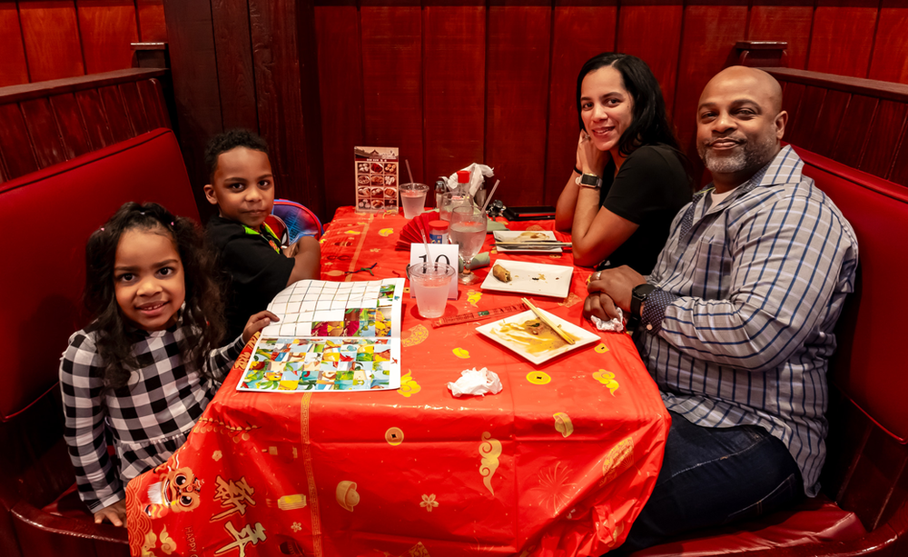 A family is sitting at a table in a restaurant.