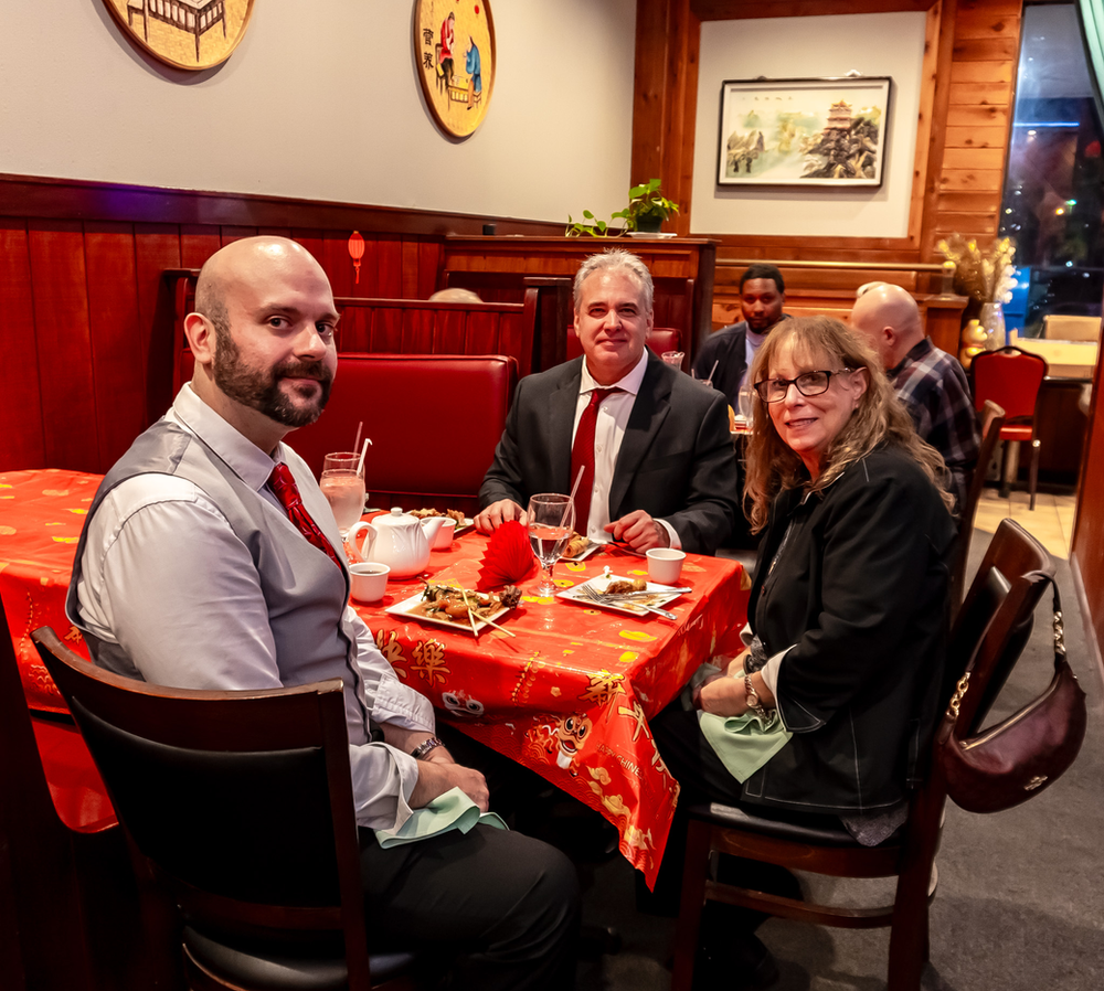 A group of people are sitting at a table in a restaurant