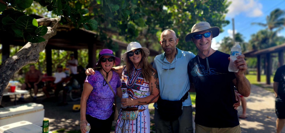 A group of people are posing for a picture in a park.