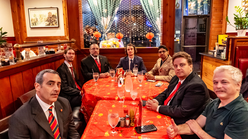 A group of men are sitting at a table in a restaurant.