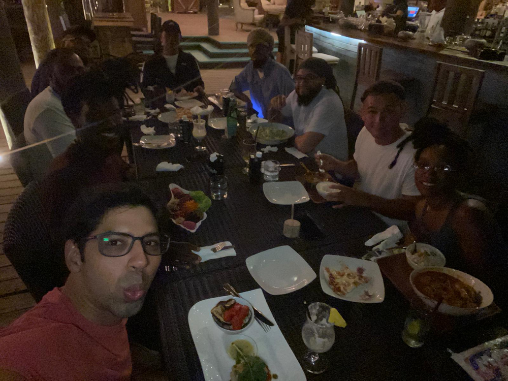 A group of people are sitting at a table with plates of food