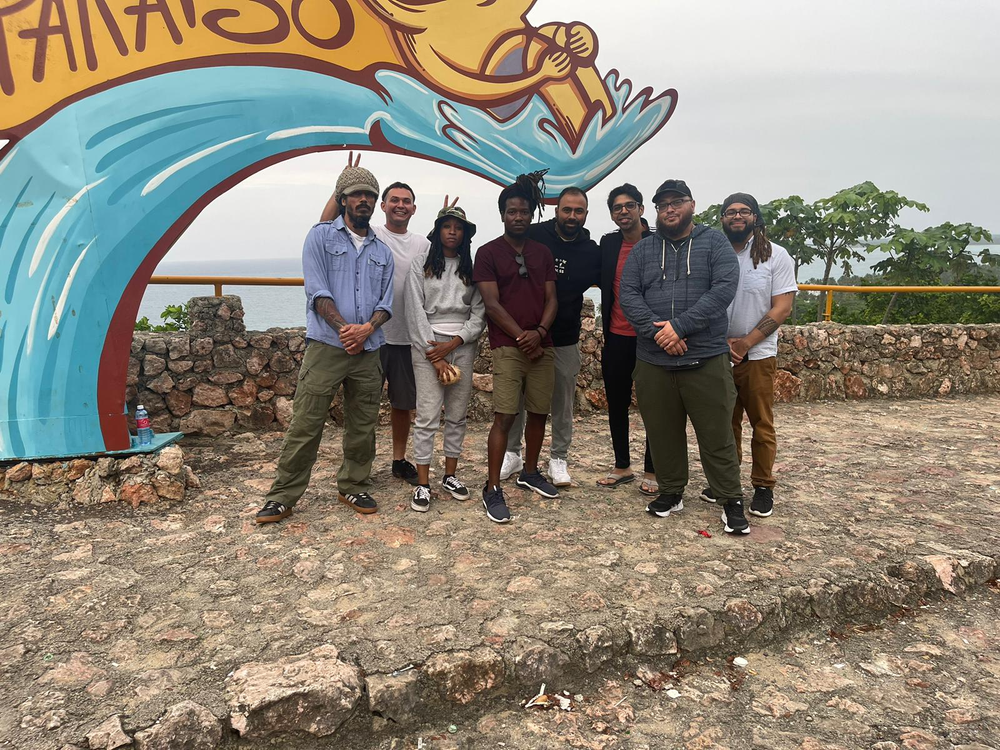 A group of people are posing for a picture in front of a sign.