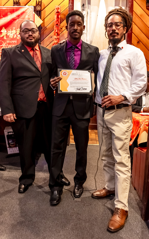 Three men are standing next to each other holding a certificate.