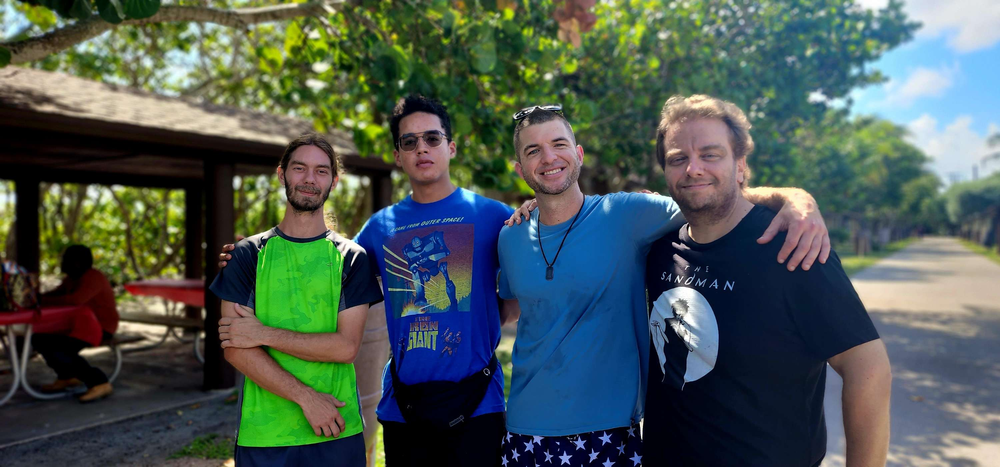 A group of young men are posing for a picture in a park.