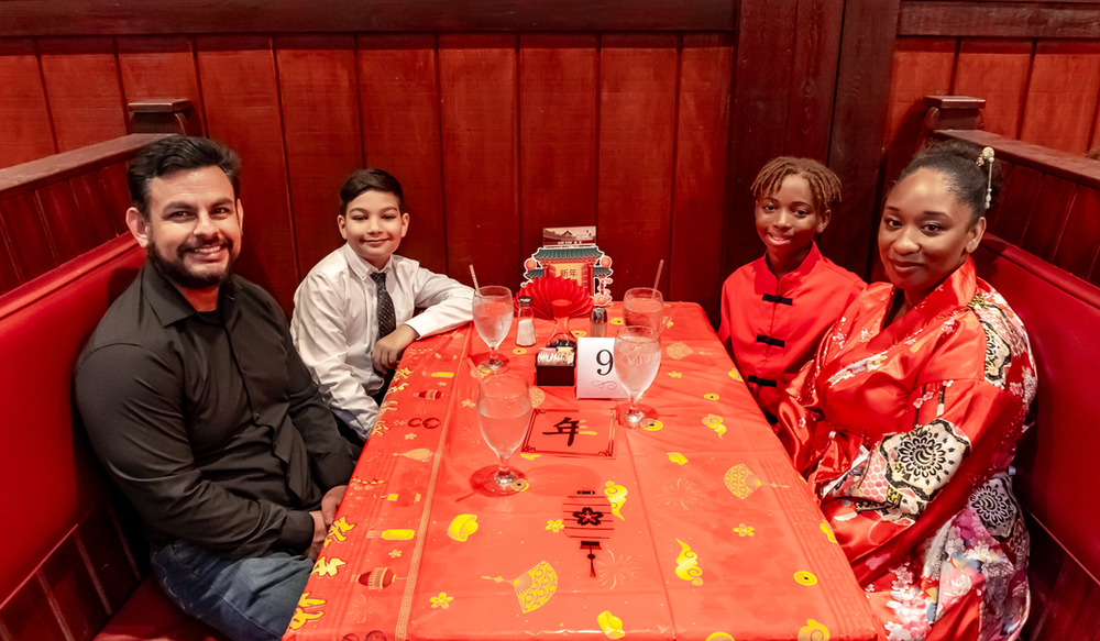 A family is sitting at a table in a restaurant.