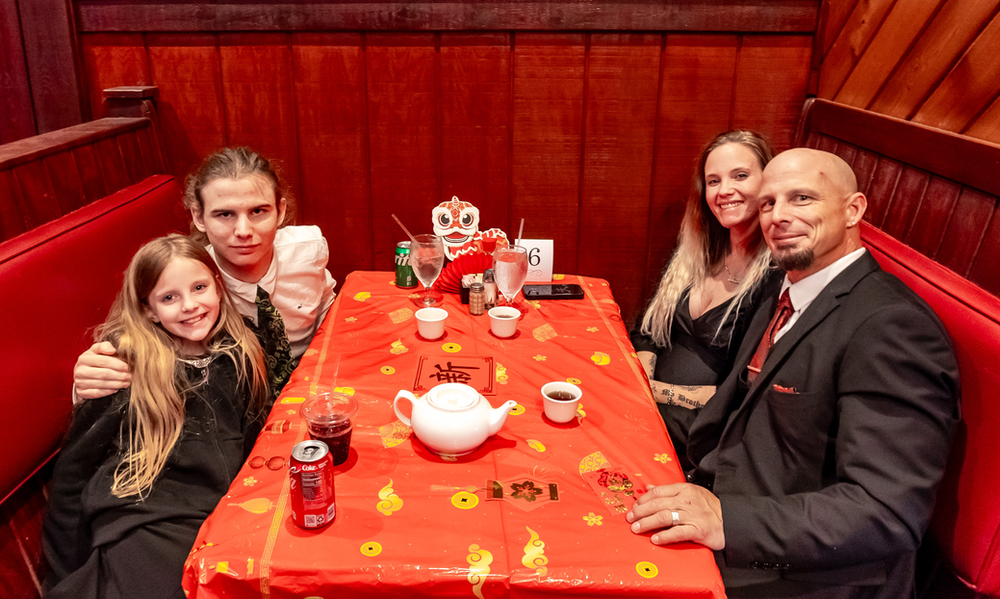 A family is sitting at a table in a restaurant.