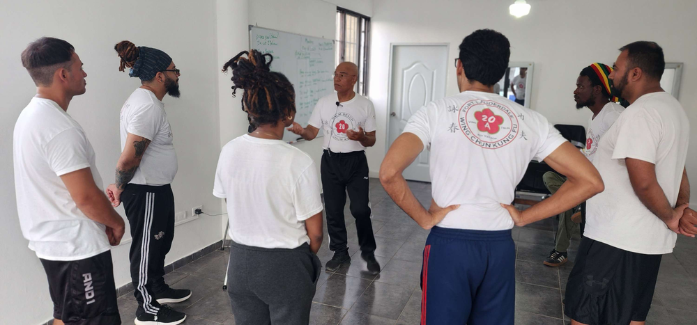 A group of people are standing in a circle in a room.