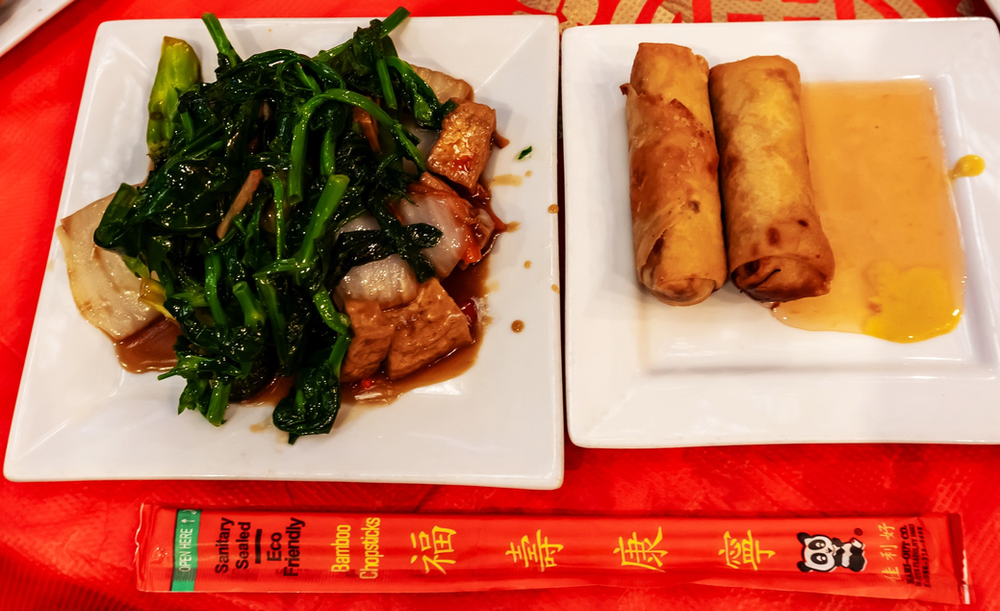 A plate of food with chopsticks next to a plate of food with chopsticks.