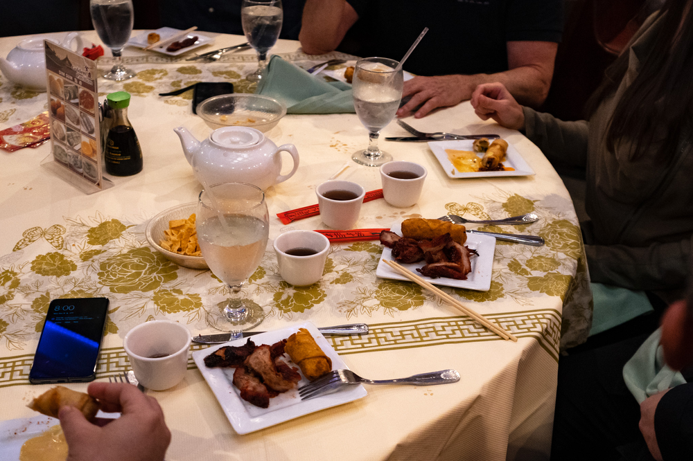 A group of people are sitting at a table eating food