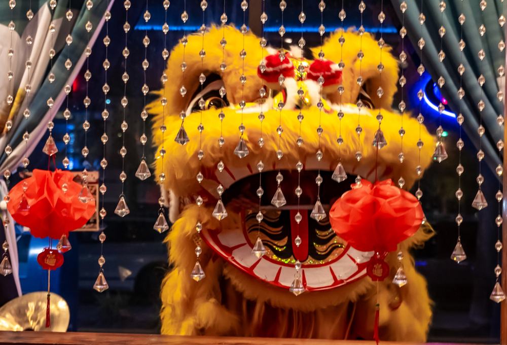 A lion statue is sitting in front of a window.