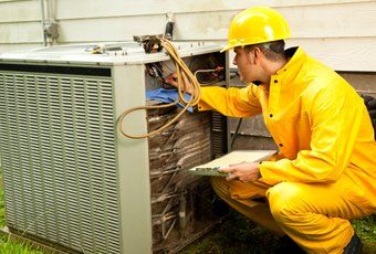 Electrician working on air conditioning unit