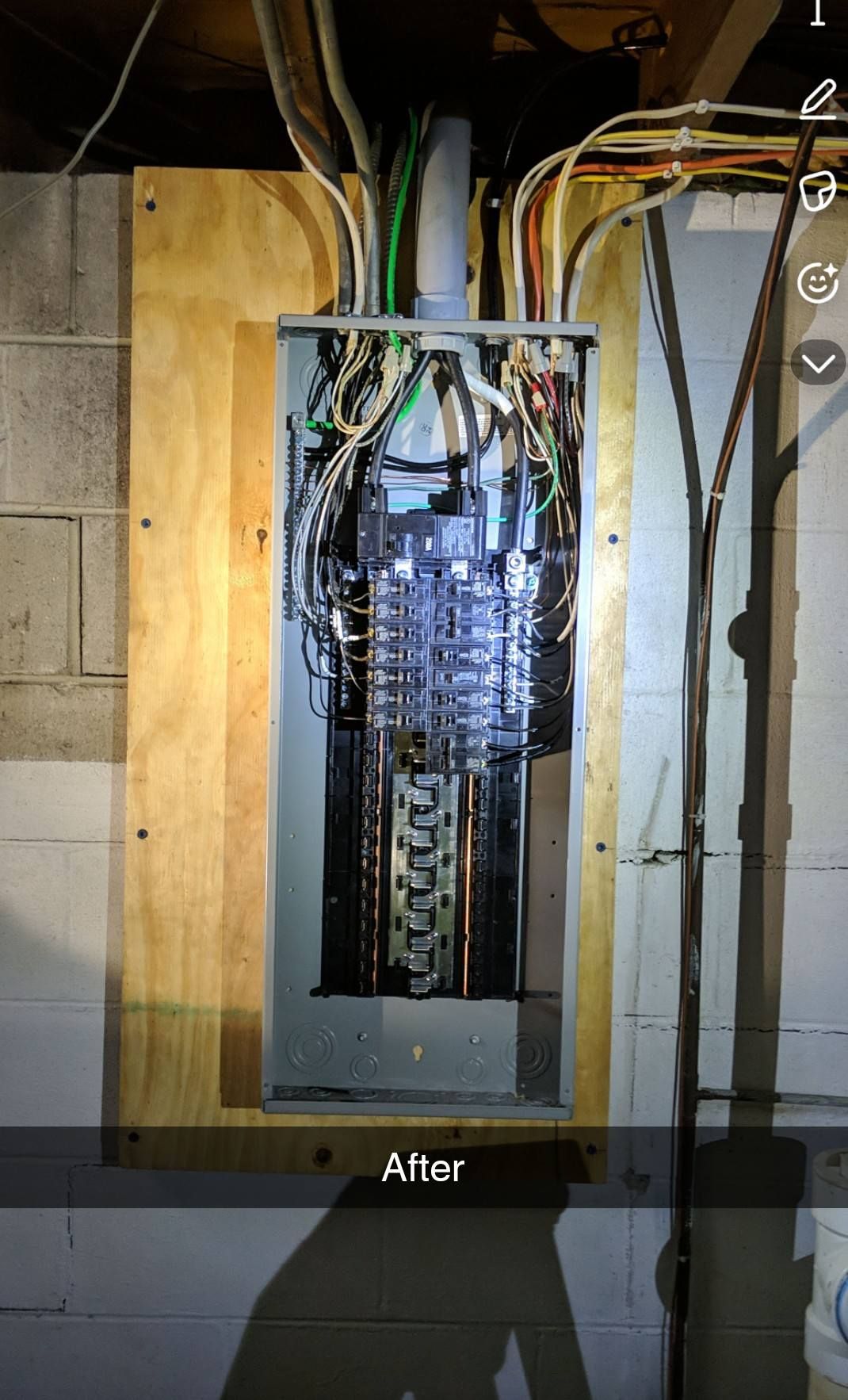 Electrical panel with exposed wiring mounted on a wooden backing, labeled “After” at the bottom.