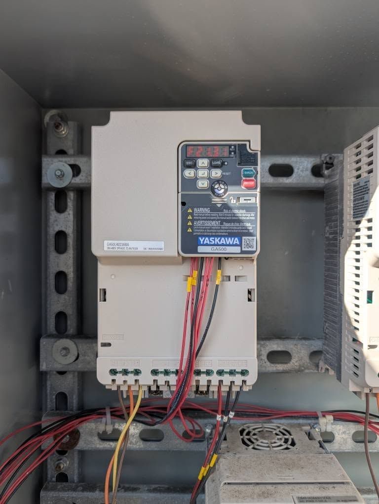 Electrical control panel with wiring and circuit breaker inside a metal enclosure