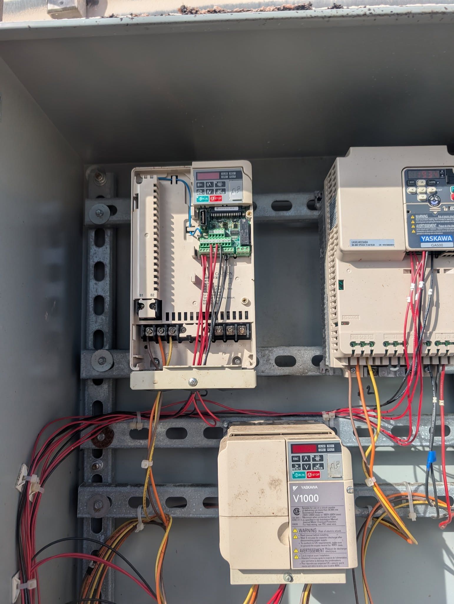 Electrical control panel with circuit breakers, wiring, and mounted components inside a metal cabinet