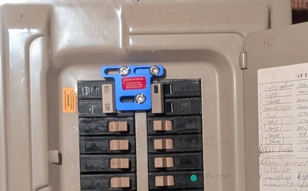 Circuit breaker panel with a blue lockout device installed on one switch.