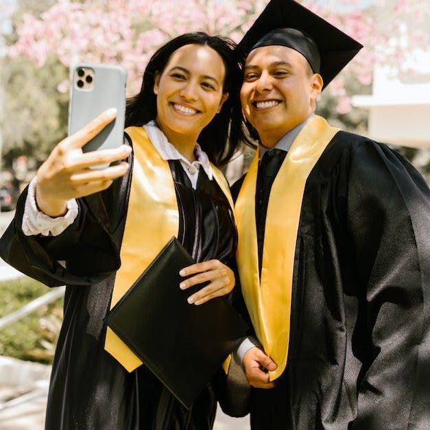 Two students  in graduation clothing