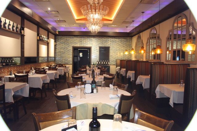 a restaurant with tables and chairs and a red exit sign
