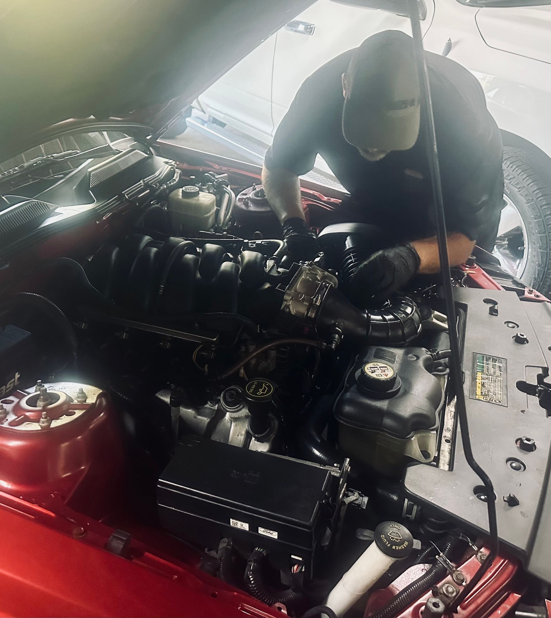 Mechanic working under hood of car | Garage 850