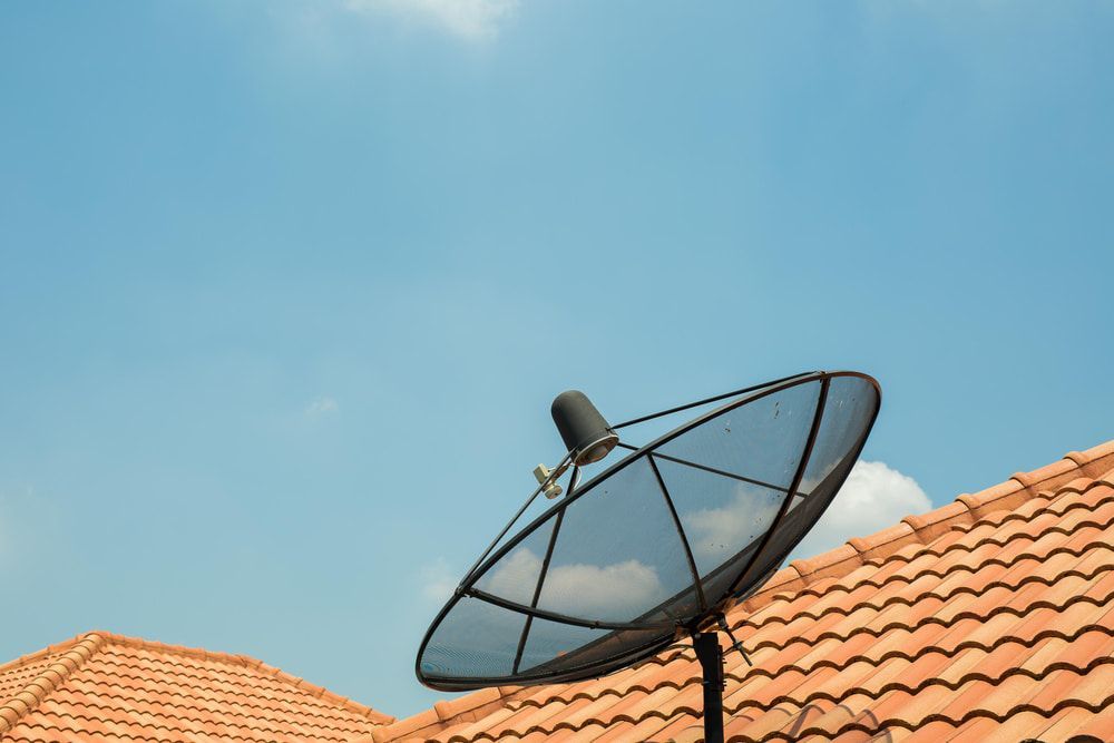 A Satellite Dish is Sitting on Top of a Tiled Roof — Audiomation in Taree, NSW