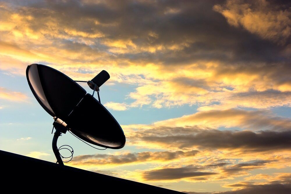 A Satellite Dish is Sitting on Top of a Roof at Sunset — Audiomation in Mid North Coast, NSW