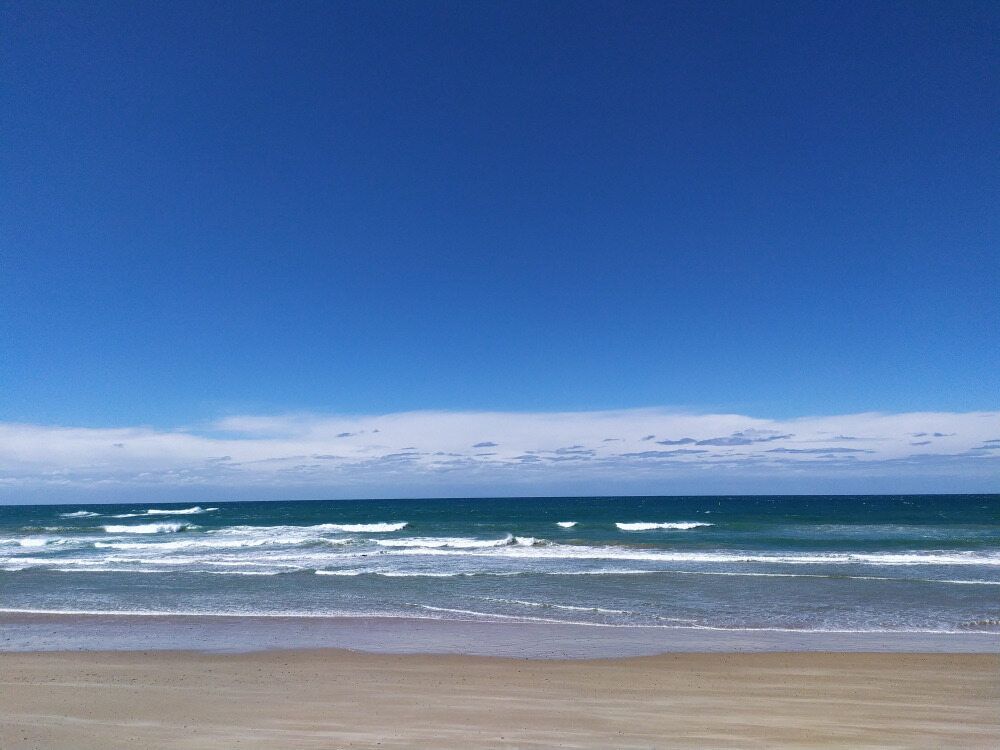 A Beach With a Blue Sky and Waves Coming in — Audiomation in Old Bar, NSW
