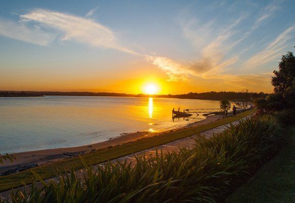A Panoramic View of a River Surrounded by Trees and Grass — Audiomation in Taree, NSW