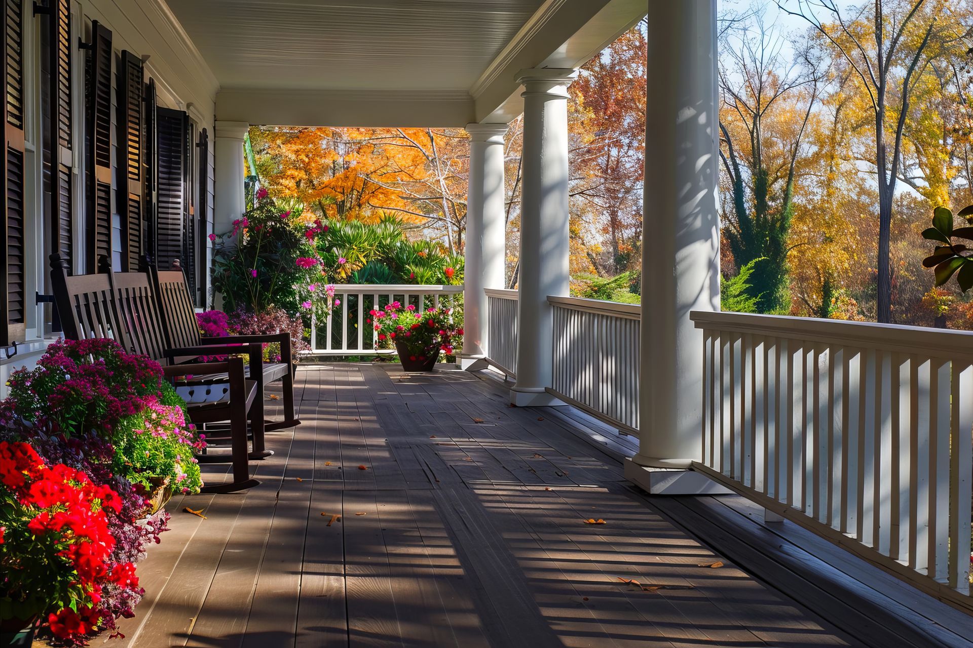 A porch with a bench and flowers on it