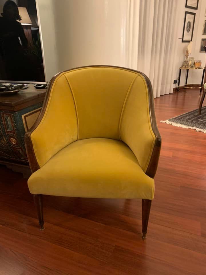 Una sedia gialla è appoggiata sul pavimento di legno in un soggiorno.