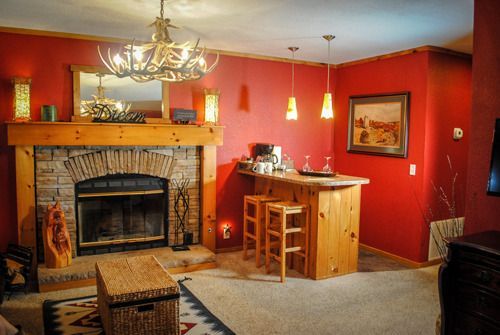 A living room with a fireplace and a bar