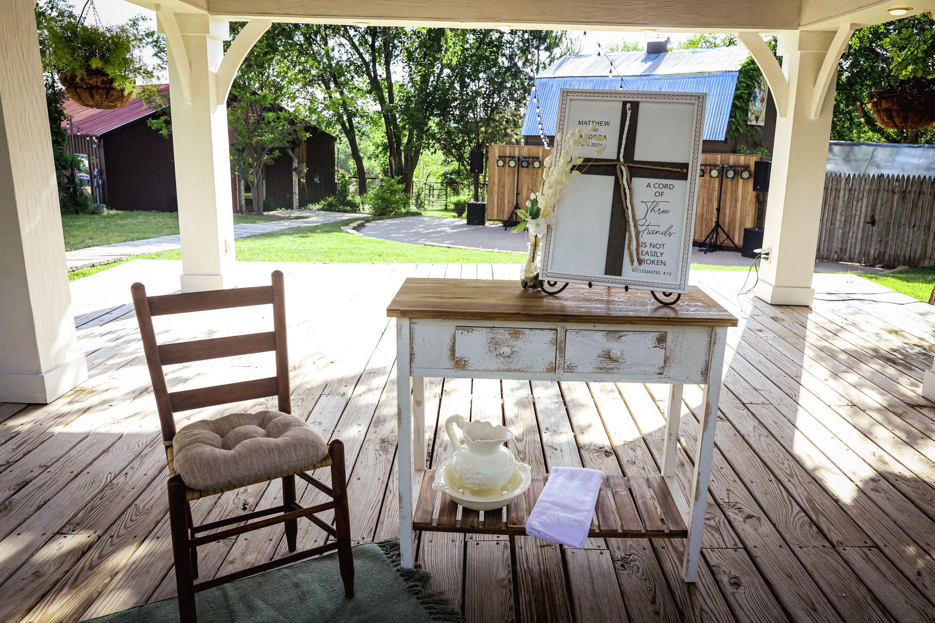 A wooden table with a cross on it is on a wooden deck.
