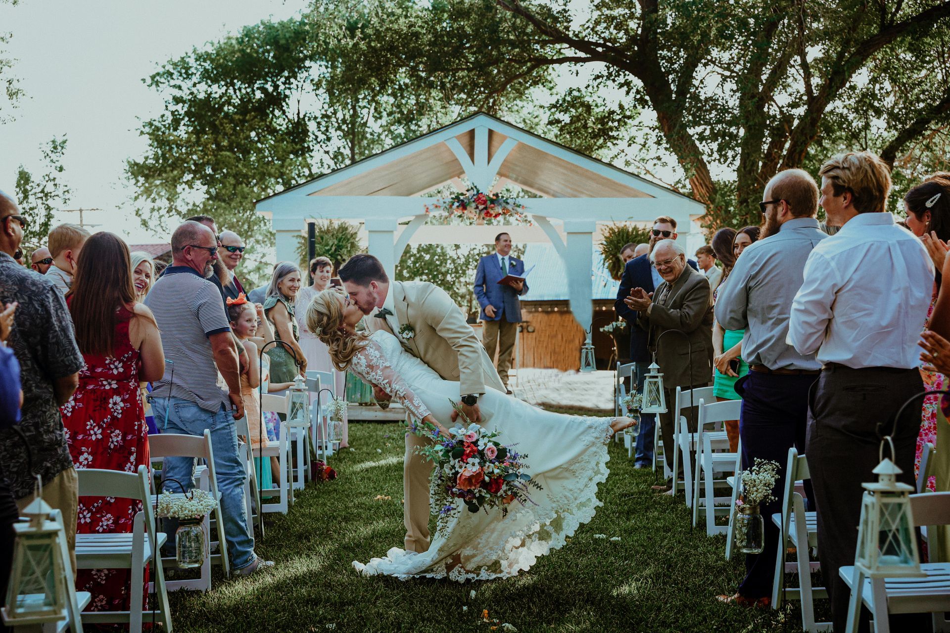 A bride and groom are walking down the aisle at a wedding ceremony.