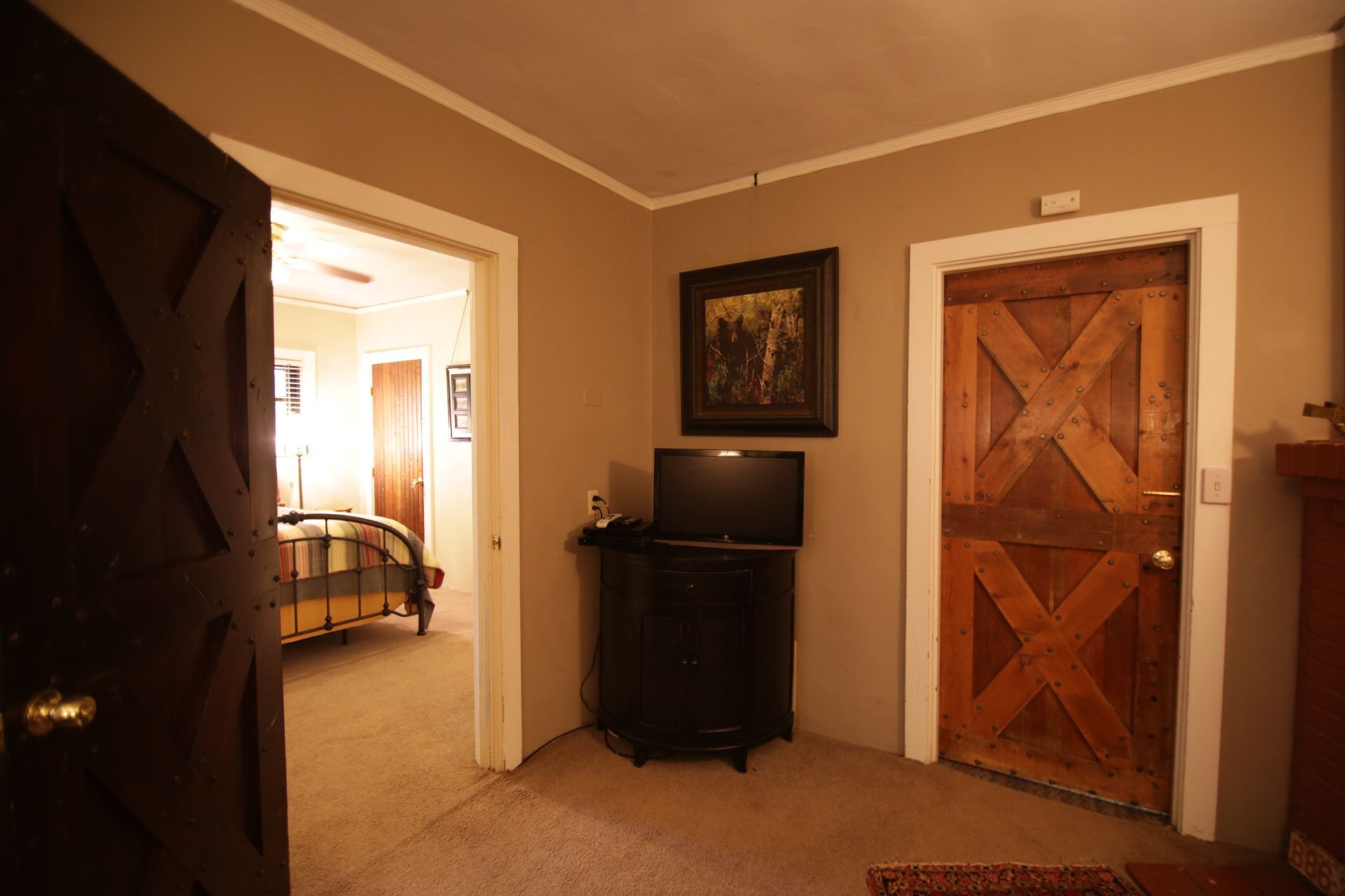 A bedroom with a bed and a television in it