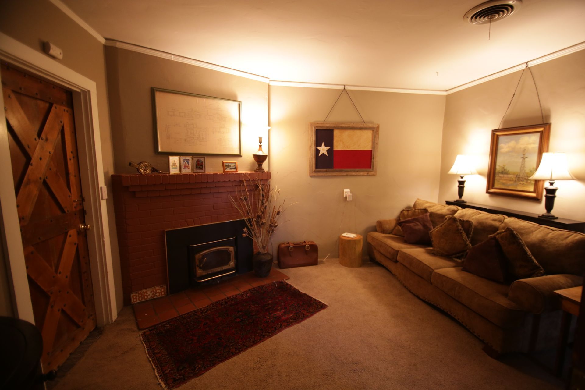 A living room with a texas flag hanging on the wall