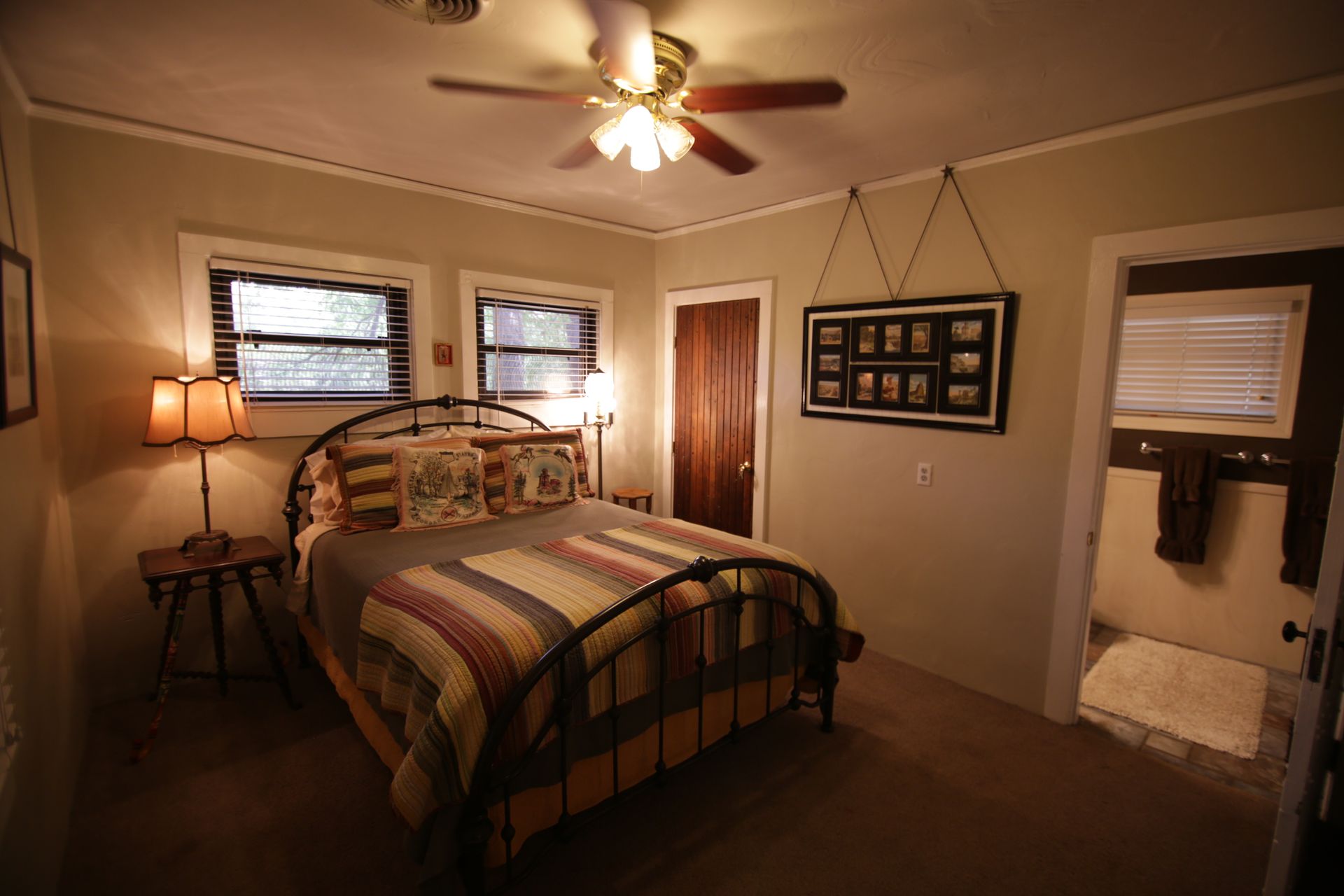 A bedroom with a bed and a ceiling fan