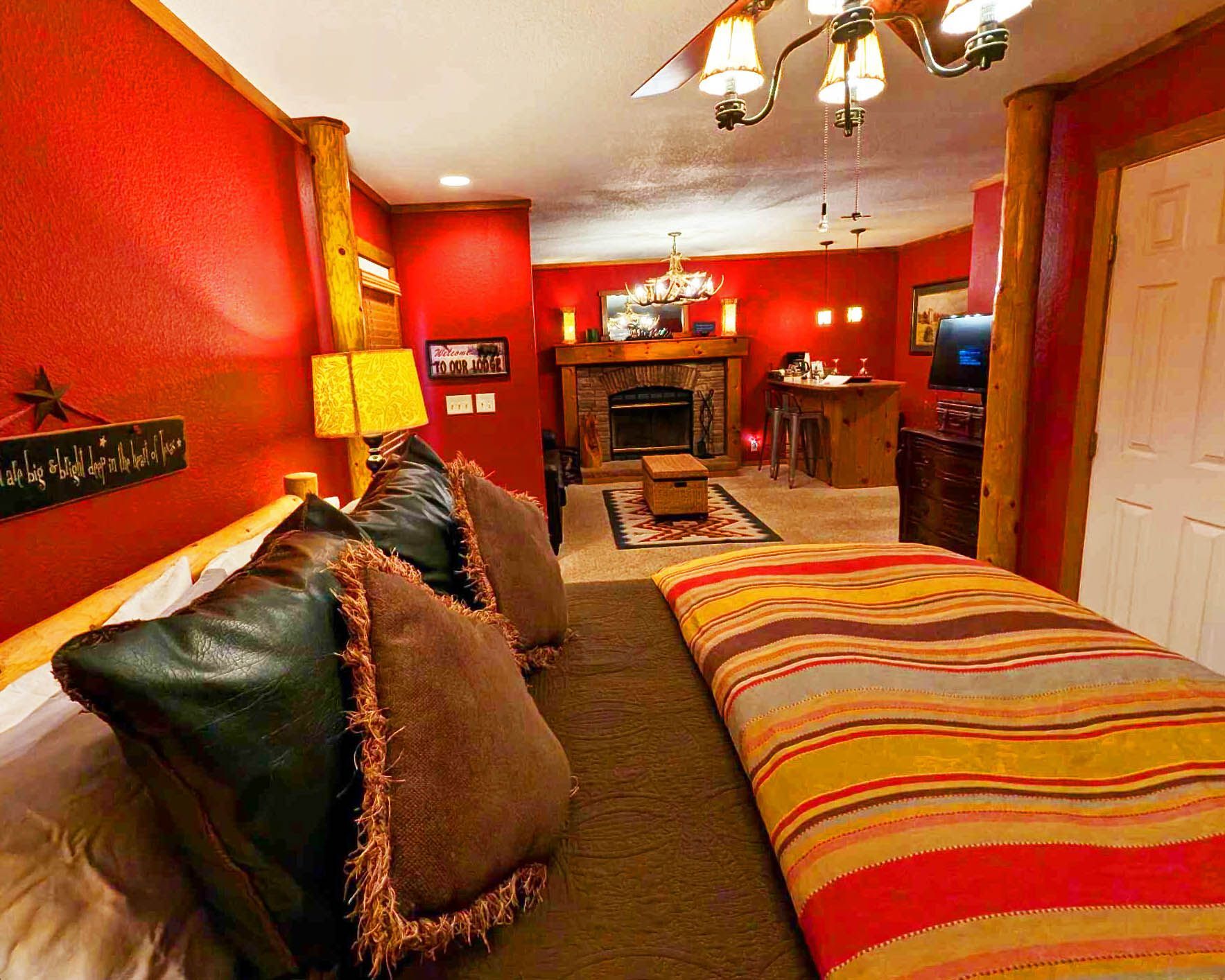 A bedroom with a king size bed and a fireplace