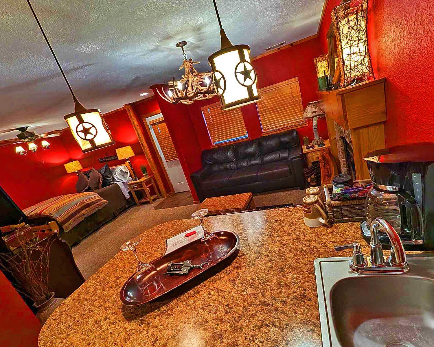 A living room with red walls and a fireplace