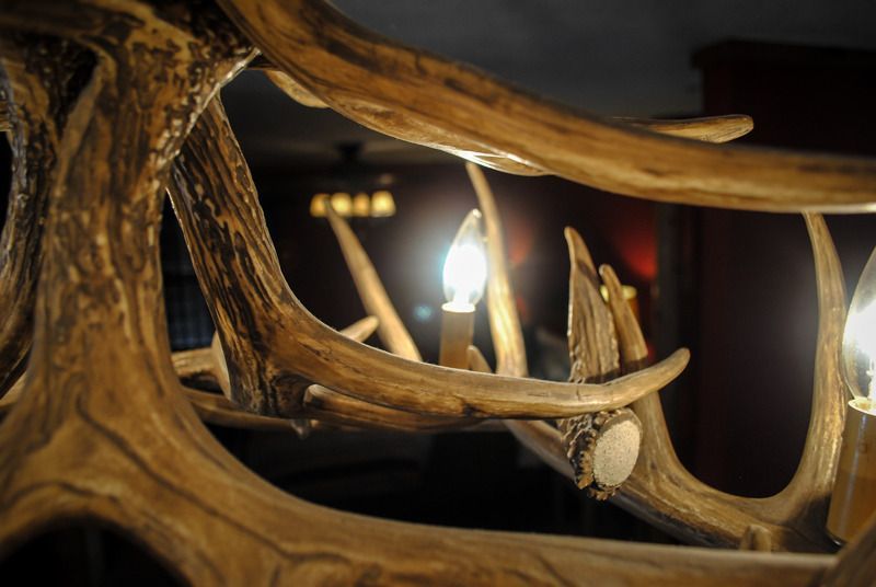 A close up of a chandelier made of deer antlers