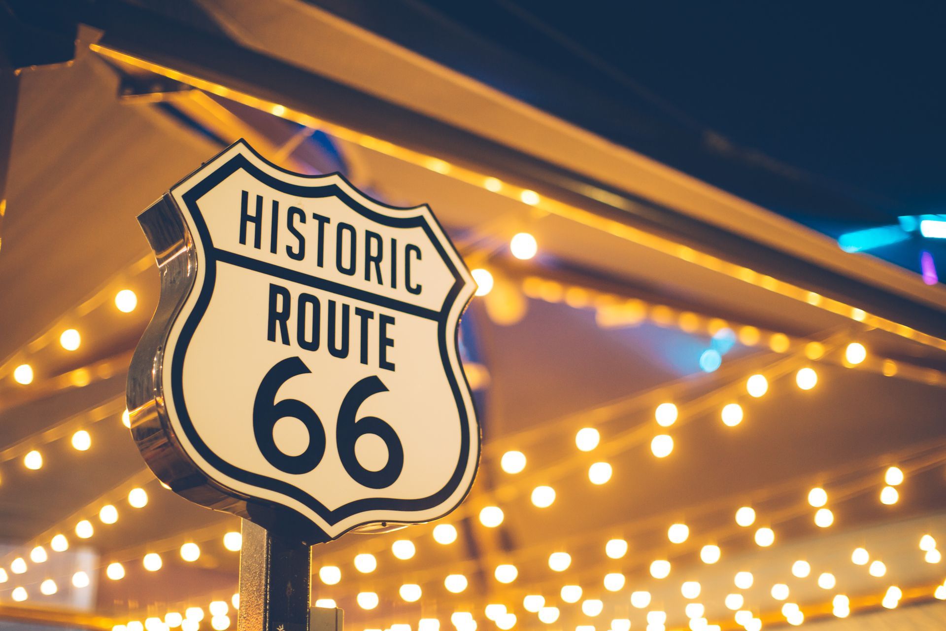 A route 66 sign is painted on the side of a road