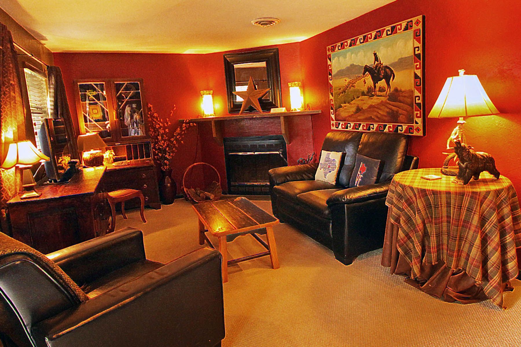 A living room with a couch a chair a table and a fireplace