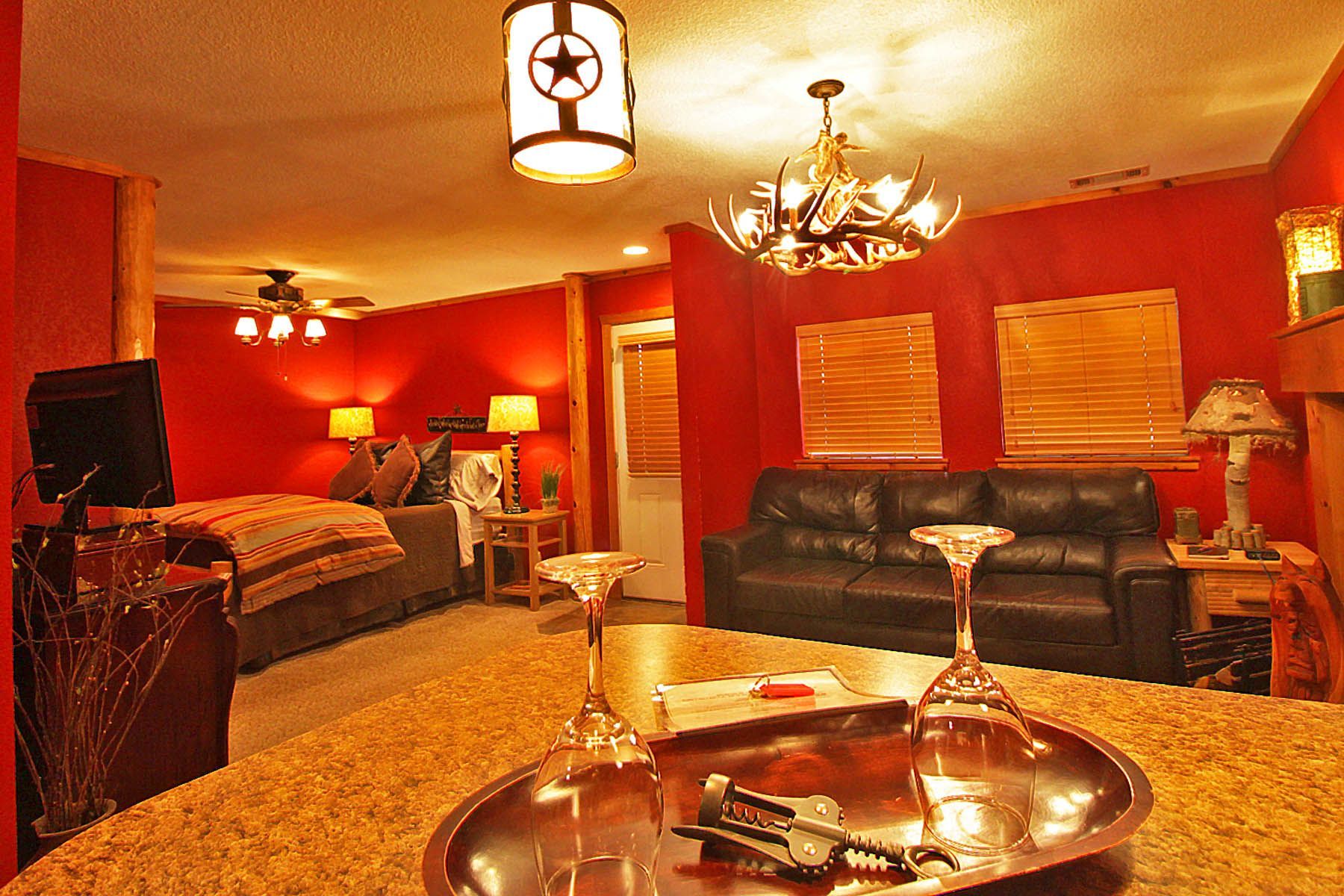 A living room with a tray of wine glasses on the table