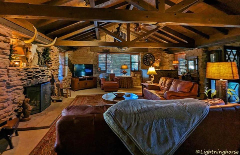 A man and a woman are sitting on a porch drinking coffee.