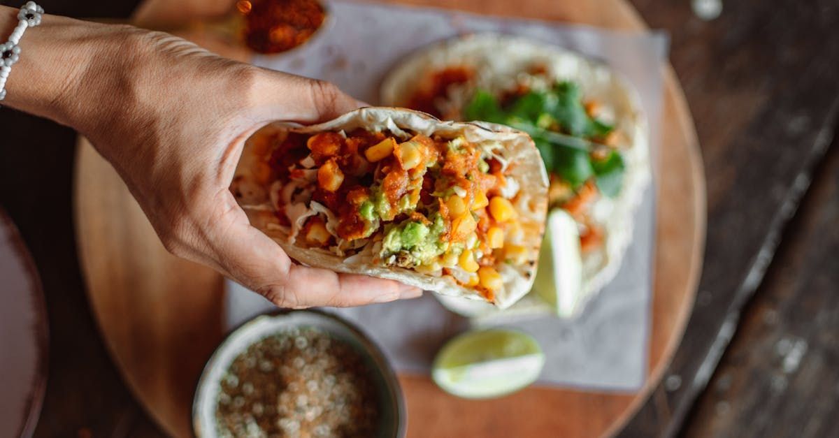 A person is holding a taco in their hand.