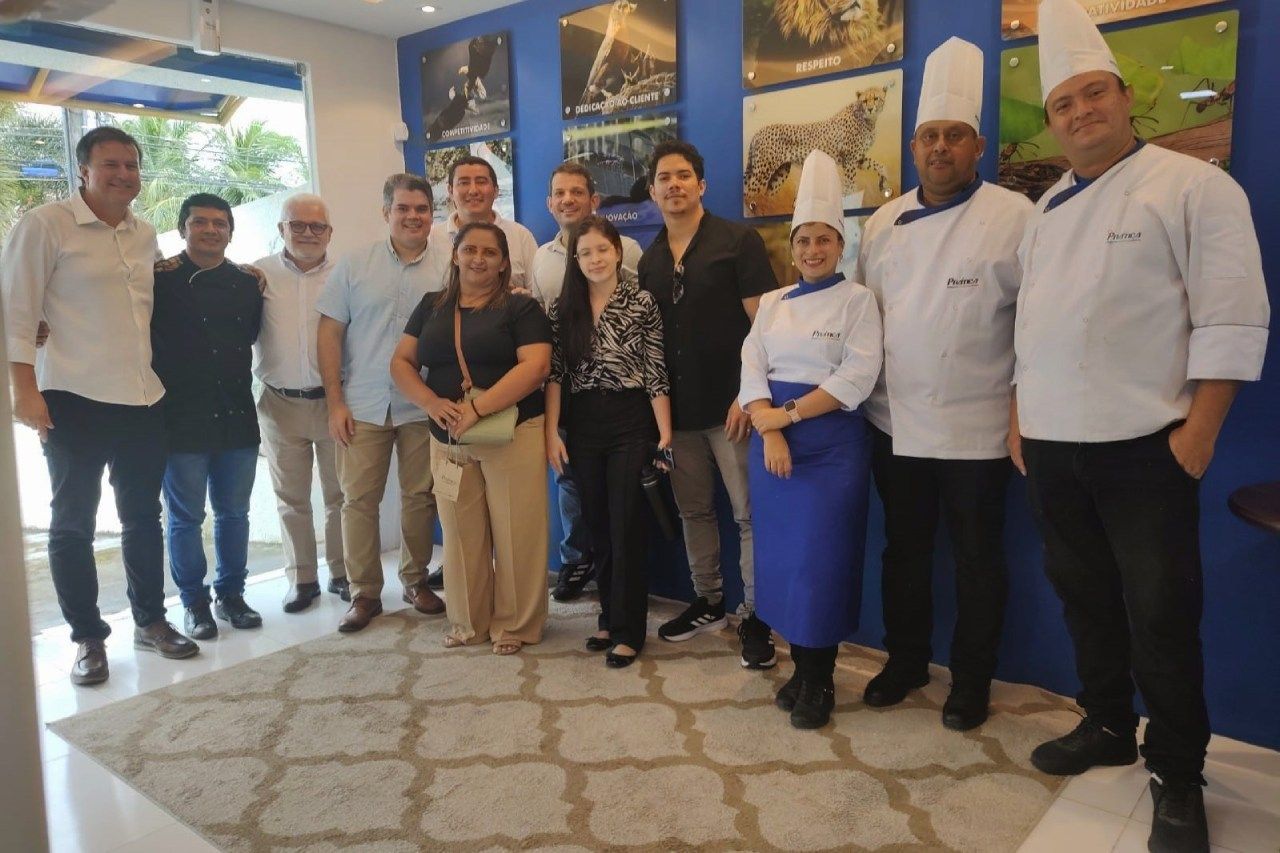 Um grupo de pessoas está posando para uma foto em uma sala.